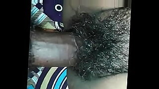 african woman gives another african woman a sex rub down in the bedroom